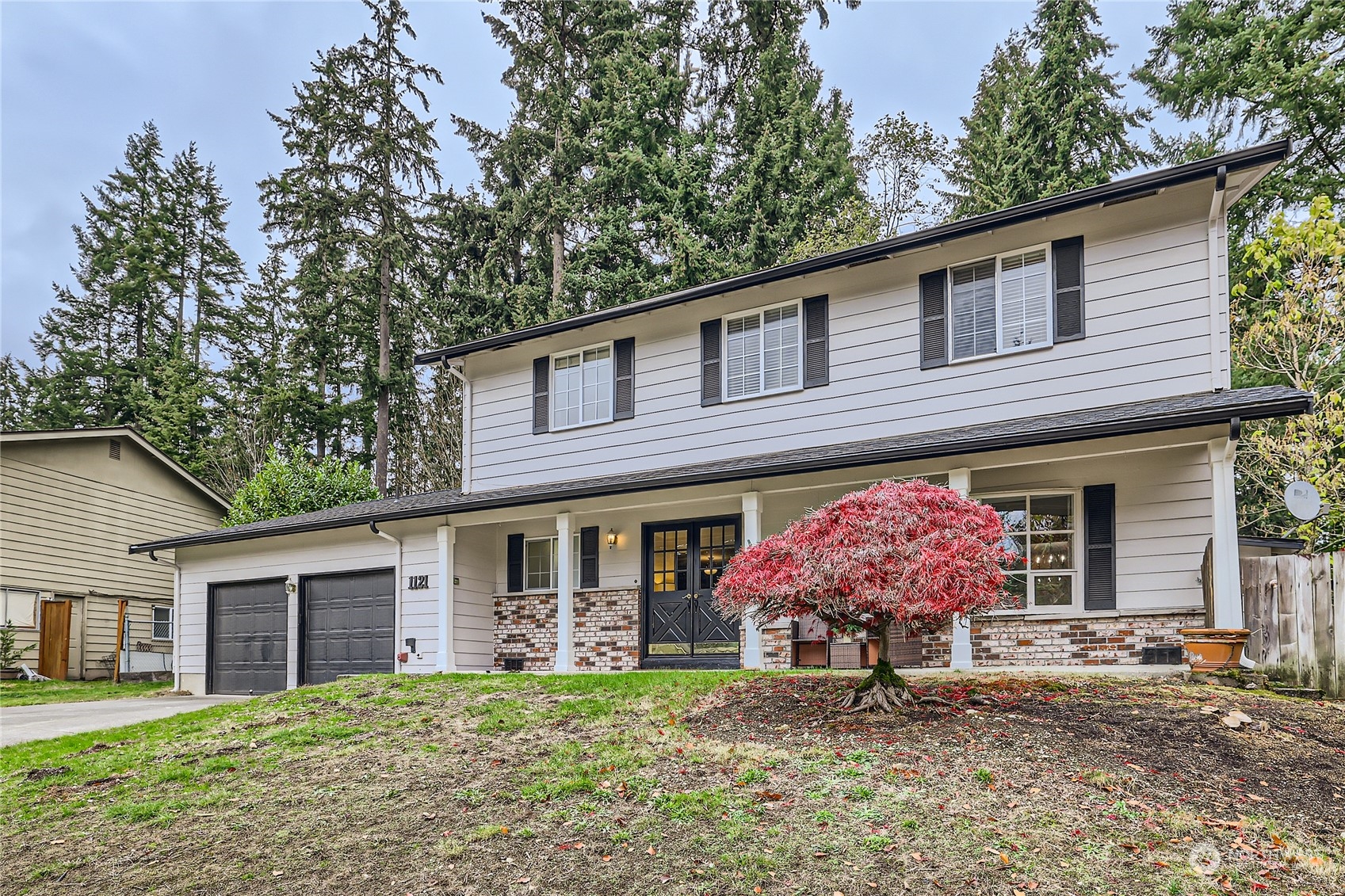1121 204th Place Southeast Bothell, WA 98012 - Photo 27 of 28 a front view of a house with garden