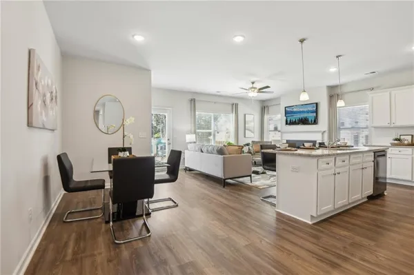 a living room with furniture and kitchen view