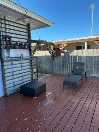 a view of a deck with furniture and wooden floor
