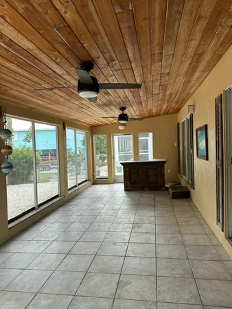 a view of empty room with wooden floor and iron stairs