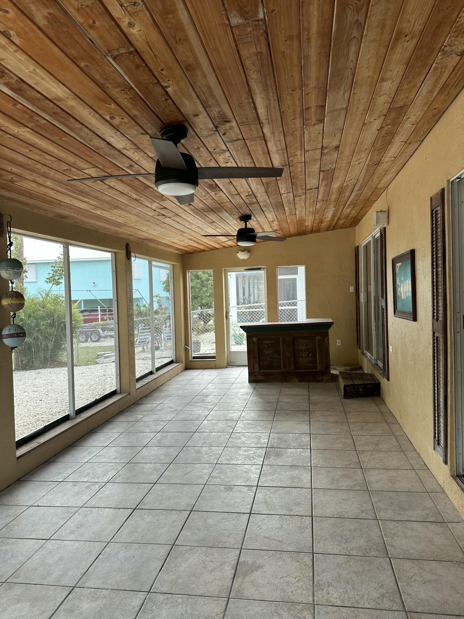 308 2nd Key Key Largo, FL 33037 - Photo 14 of 17 a view of empty room with wooden floor and iron stairs