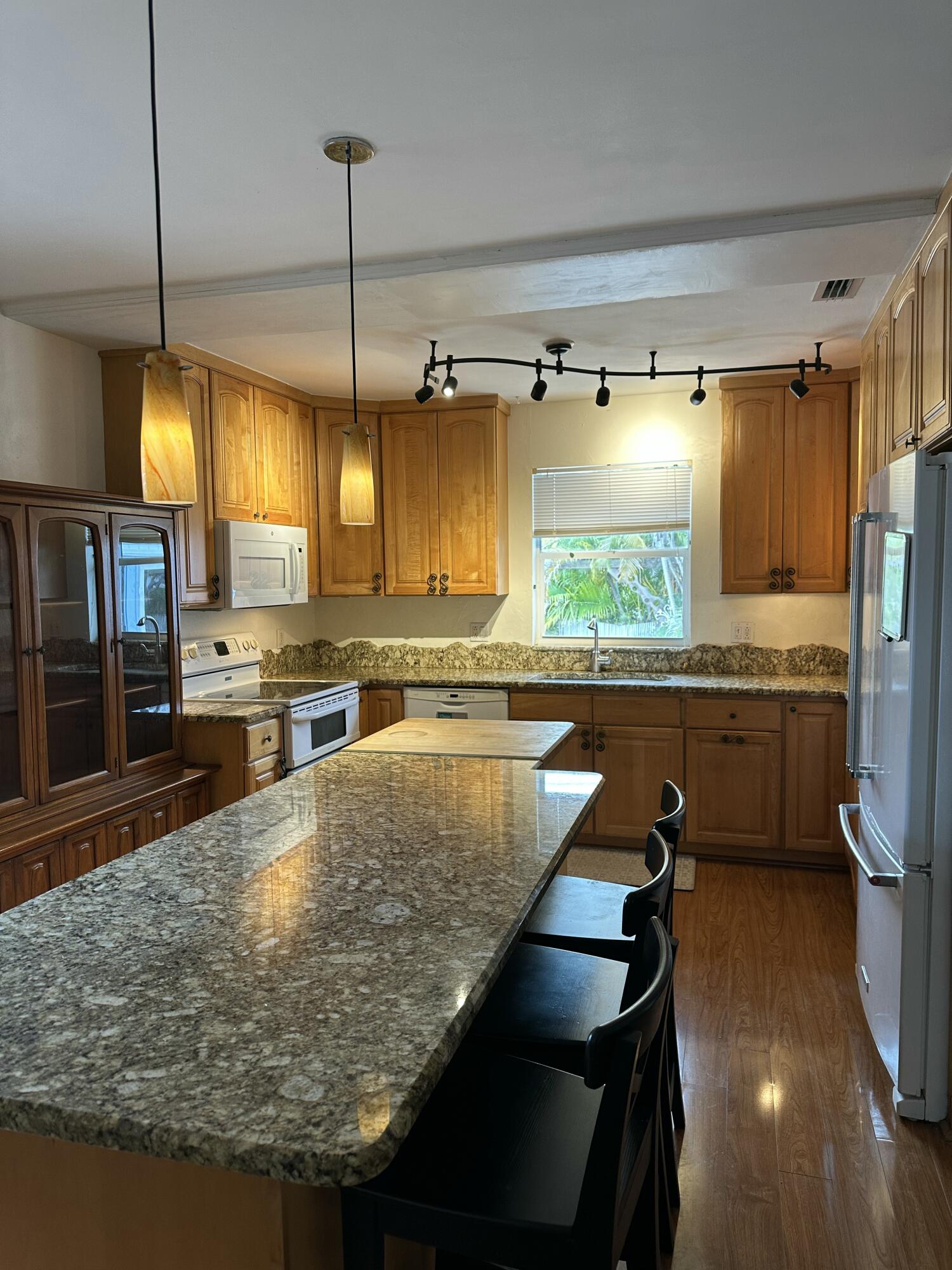 308 2nd Key Key Largo, FL 33037 - Photo 3 of 17 a kitchen with stainless steel appliances granite countertop a sink a stove and a wooden floors