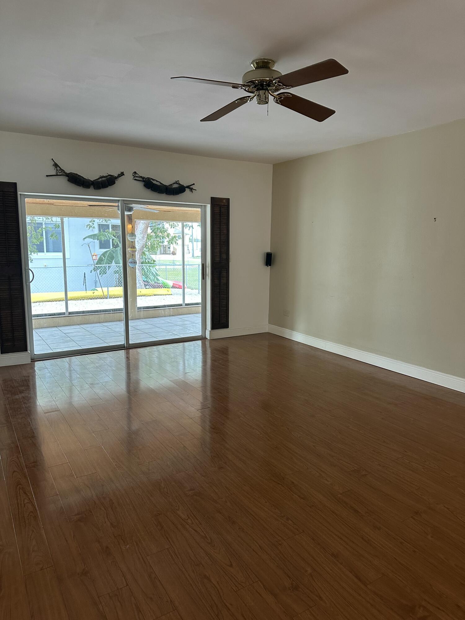 308 2nd Key Key Largo, FL 33037 - Photo 6 of 17 a view of an empty room with wooden floor and a window