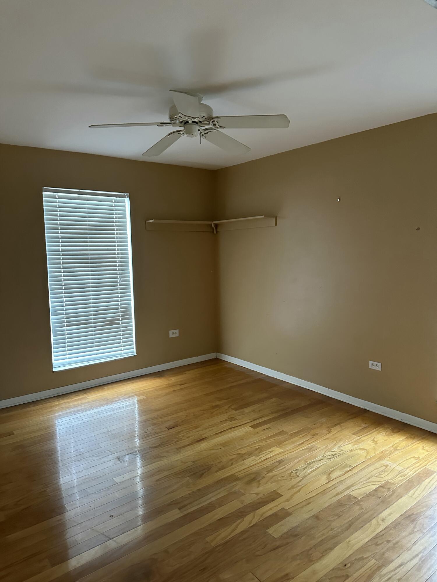 308 2nd Key Key Largo, FL 33037 - Photo 9 of 17 a view of an empty room with wooden floor and a window