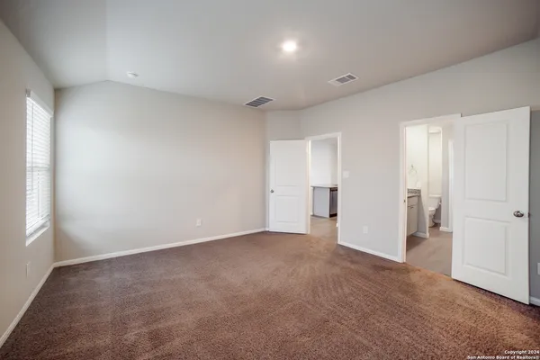 a view of an empty room and a window