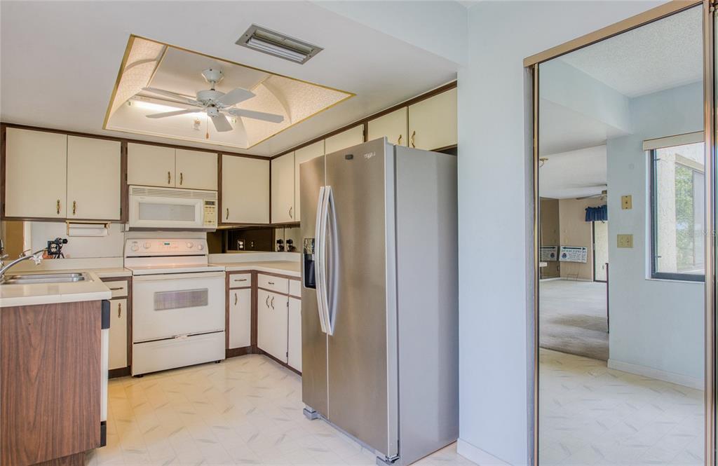 700 Starkey Road, Unit 1145 Largo, FL 33771 - Photo 8 of 63 a kitchen with white cabinets and white appliances