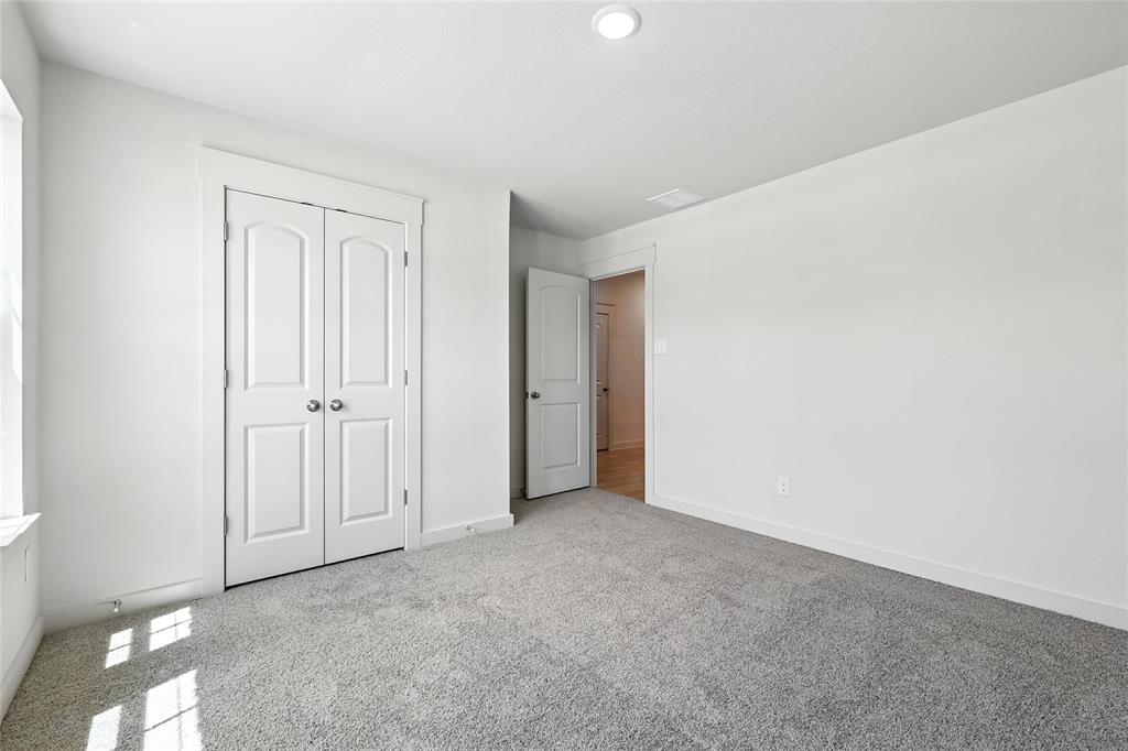1795 Gleasondale Place Forney, TX 75126 - Photo 23 of 29 Unfurnished bedroom featuring carpet floors and a closet