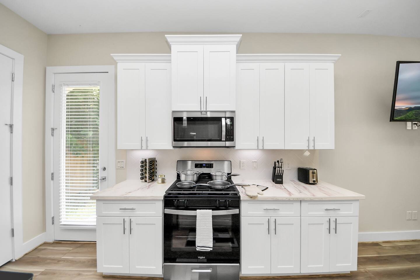 5935 Beall Street, Unit B Houston, TX 77091 - Photo 15 of 50 a kitchen with stainless steel appliances white cabinets and a stove