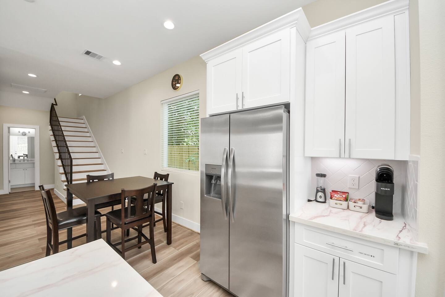 5935 Beall Street, Unit B Houston, TX 77091 - Photo 17 of 50 a kitchen with stainless steel appliances kitchen island granite countertop a table chairs and a refrigerator