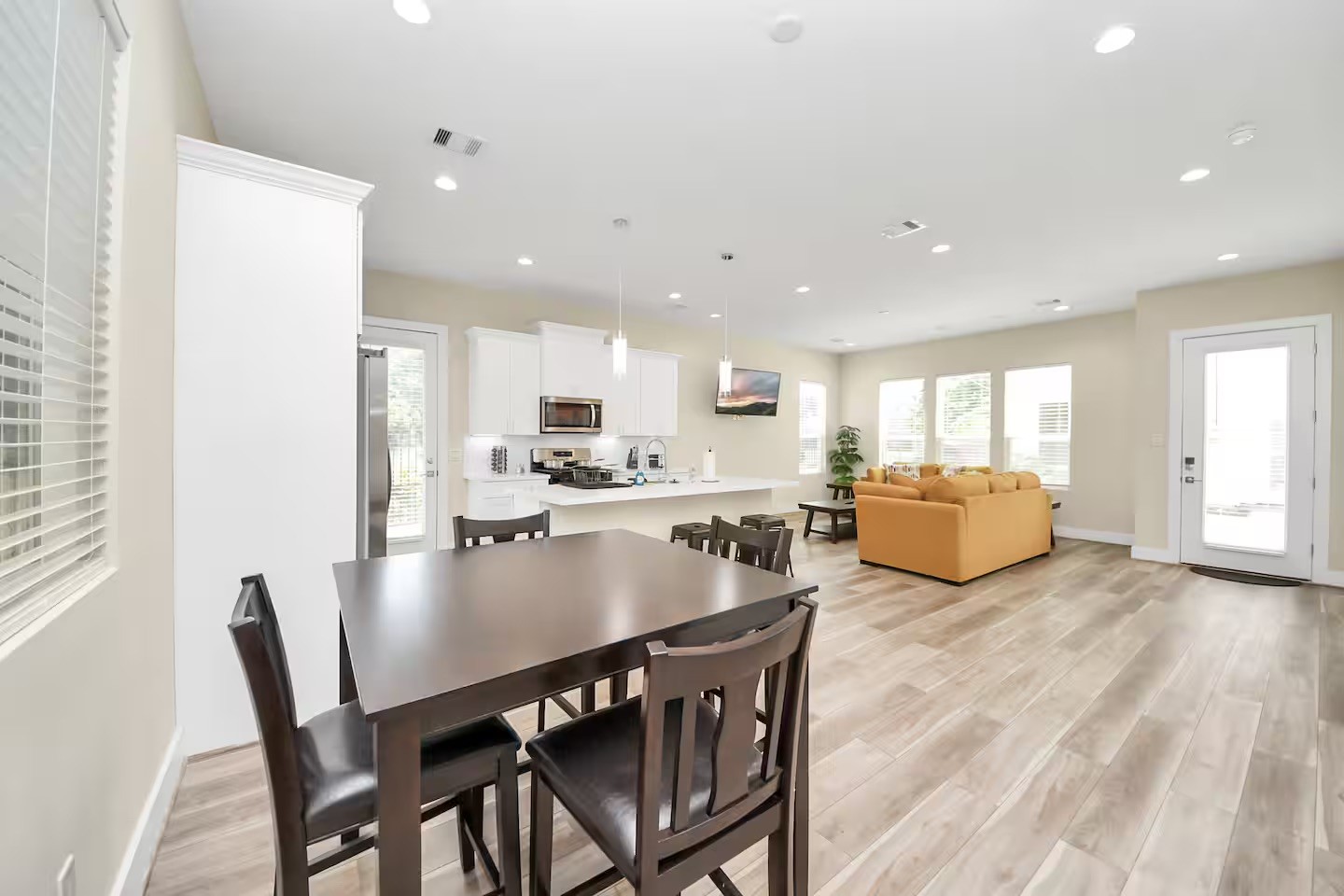 5935 Beall Street, Unit B Houston, TX 77091 - Photo 18 of 50 a living room with stainless steel appliances kitchen island granite countertop a dining table chairs and a refrigerator