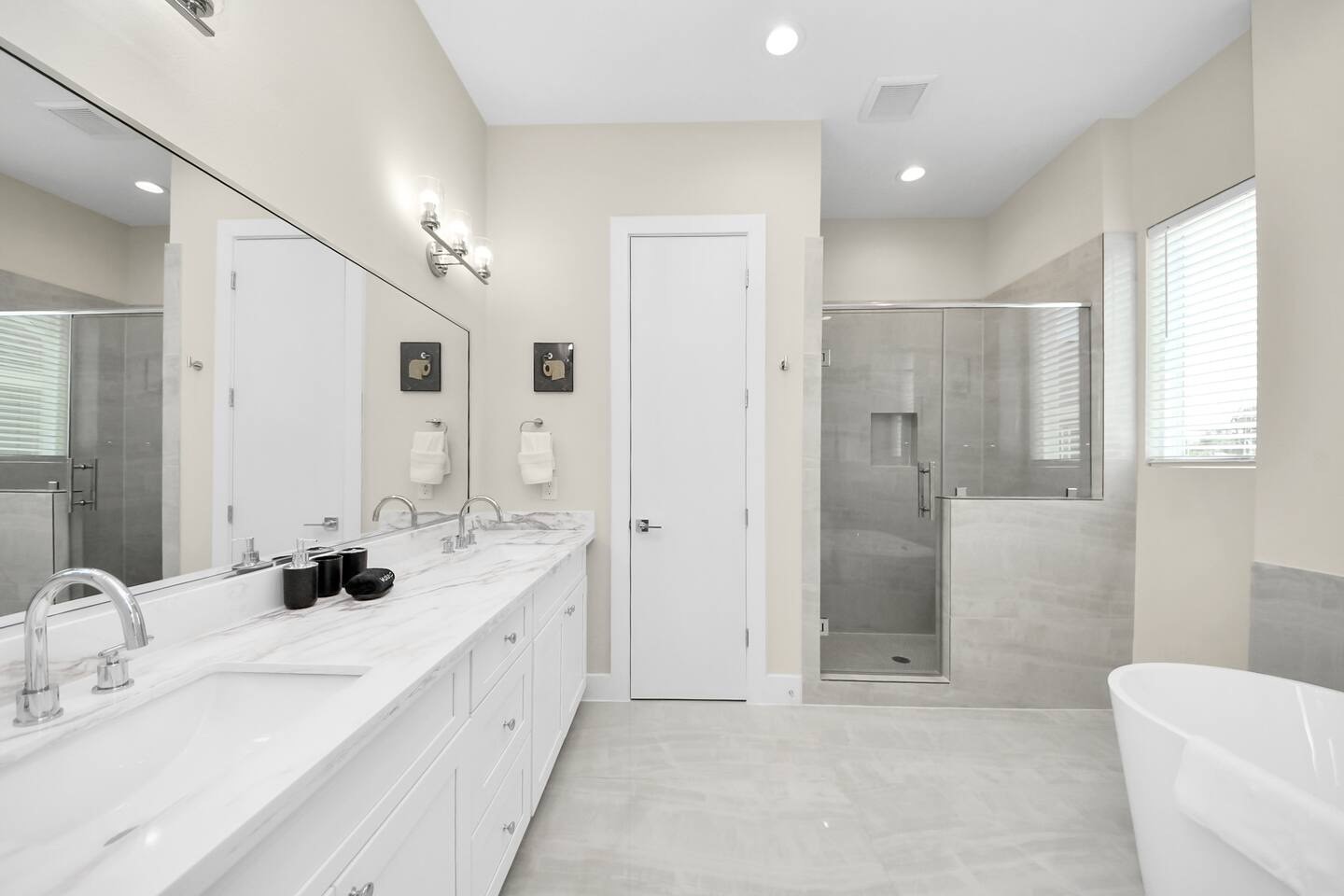 5935 Beall Street, Unit B Houston, TX 77091 - Photo 29 of 50 a large bathroom with a double vanity sink a toilet a mirror and shower