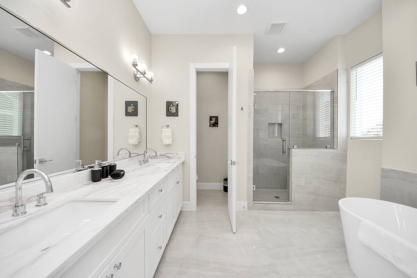 5935 Beall Street, Unit B Houston, TX 77091 - Photo 31 of 50 a bathroom with a double vanity sink mirror double shower and bathtub