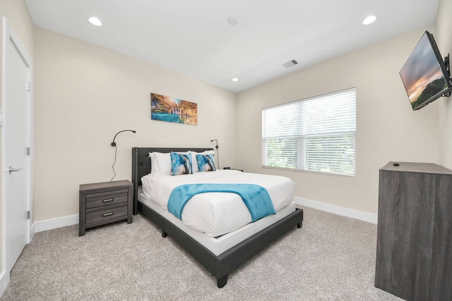 5935 Beall Street, Unit B Houston, TX 77091 - Photo 37 of 50 a bedroom with a bed and a flat screen tv