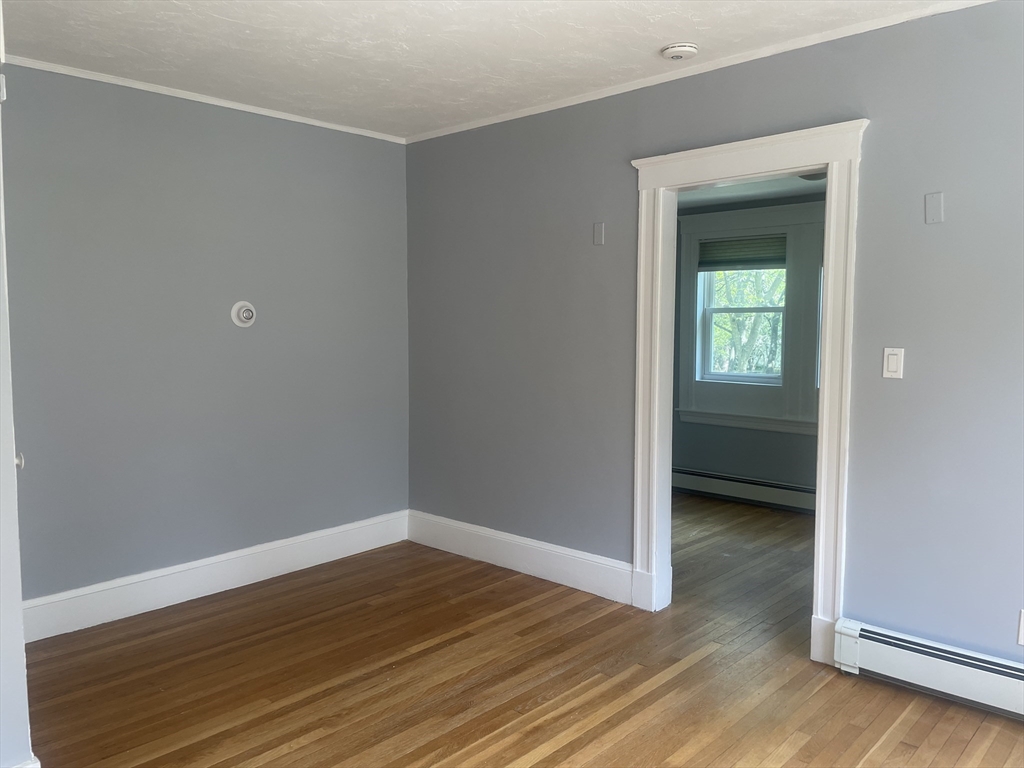 21 Arbor Lane, Unit 21 Dedham, MA 02026 - Photo 8 of 10 a view of an empty room with closet and a window