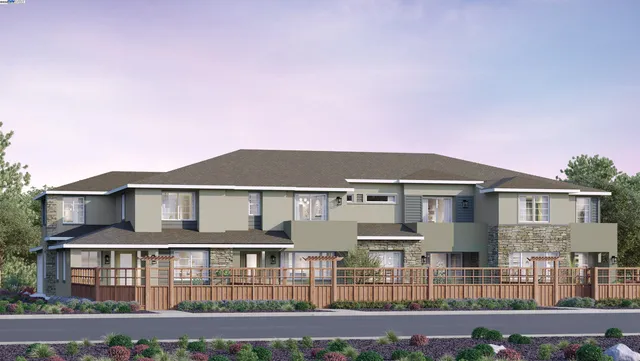 a front view of a house with glass windows and yard