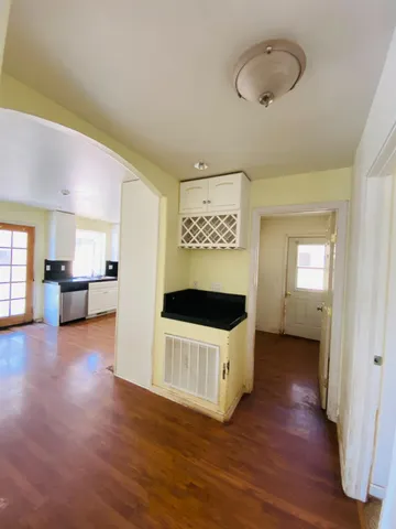 a view of a room with wooden floor and window
