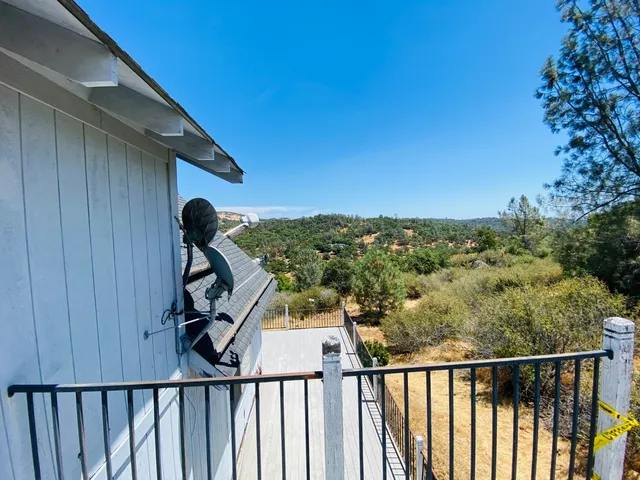 a view of a balcony with wooden fence and floor