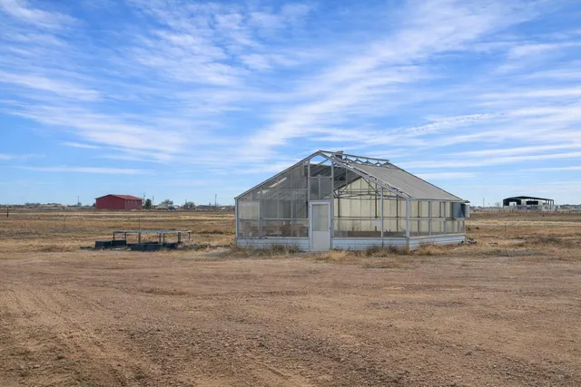 a bedroom with furniture and a wooden floor