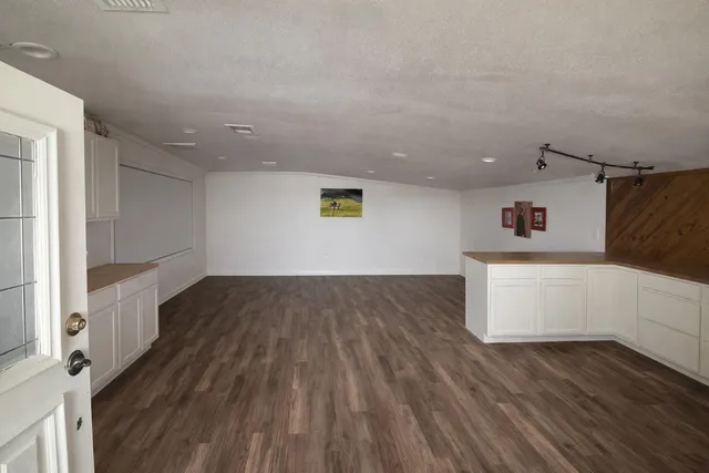 a view of an empty room with shelves