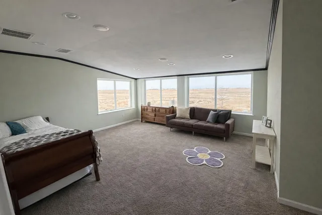 a view of an empty room with a cabinet and a window