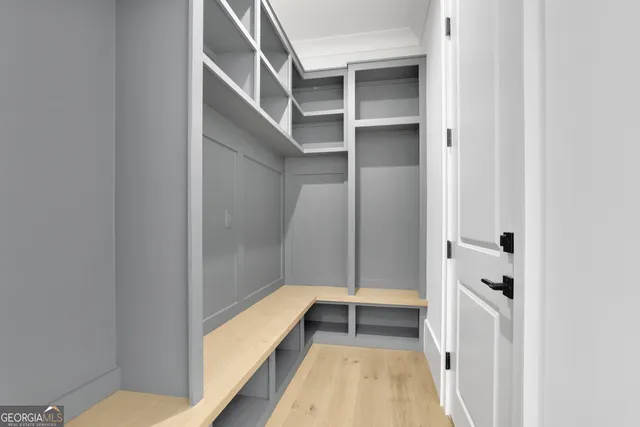 a view of an empty room with furniture and window