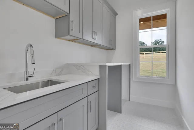 a bathroom with a sink a shower and a mirror
