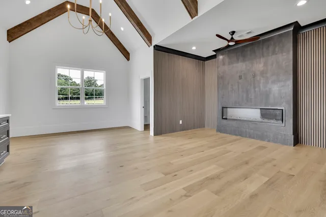 a spacious bathroom with a double vanity sink a large mirror and a bathtub