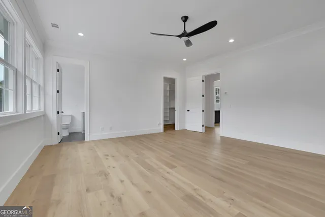 a bathroom with a granite countertop sink a toilet a mirror and shower