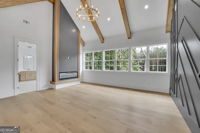 an empty room with closet and a ceiling fan
