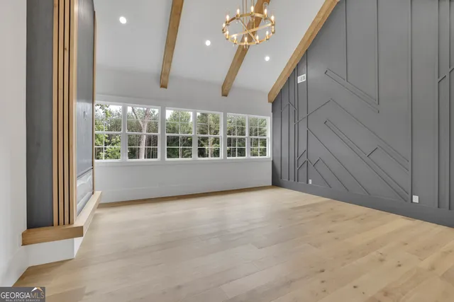 a spacious bathroom with a granite countertop sink a toilet a large mirror and vanity