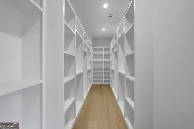 a spacious bathroom with a double vanity sink mirror and shower