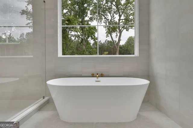 a white bath tub sitting in front of a window