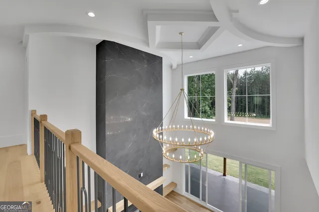 a view of a house with a big yard and large trees