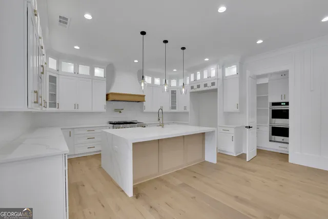 a kitchen with white cabinets and white appliances
