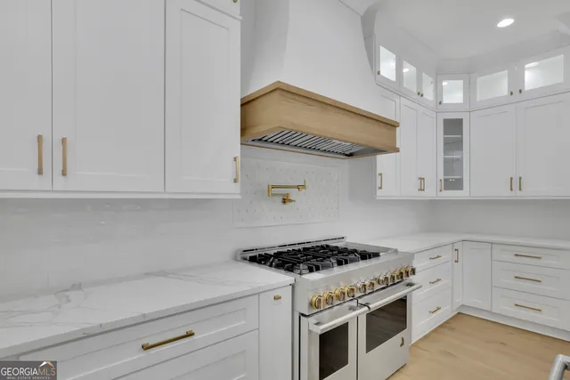 a view of an empty room with a kitchen view