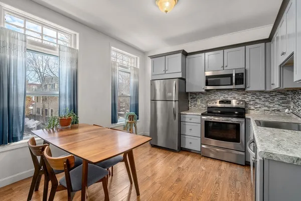 a view of a dining room with furniture and wooden floor