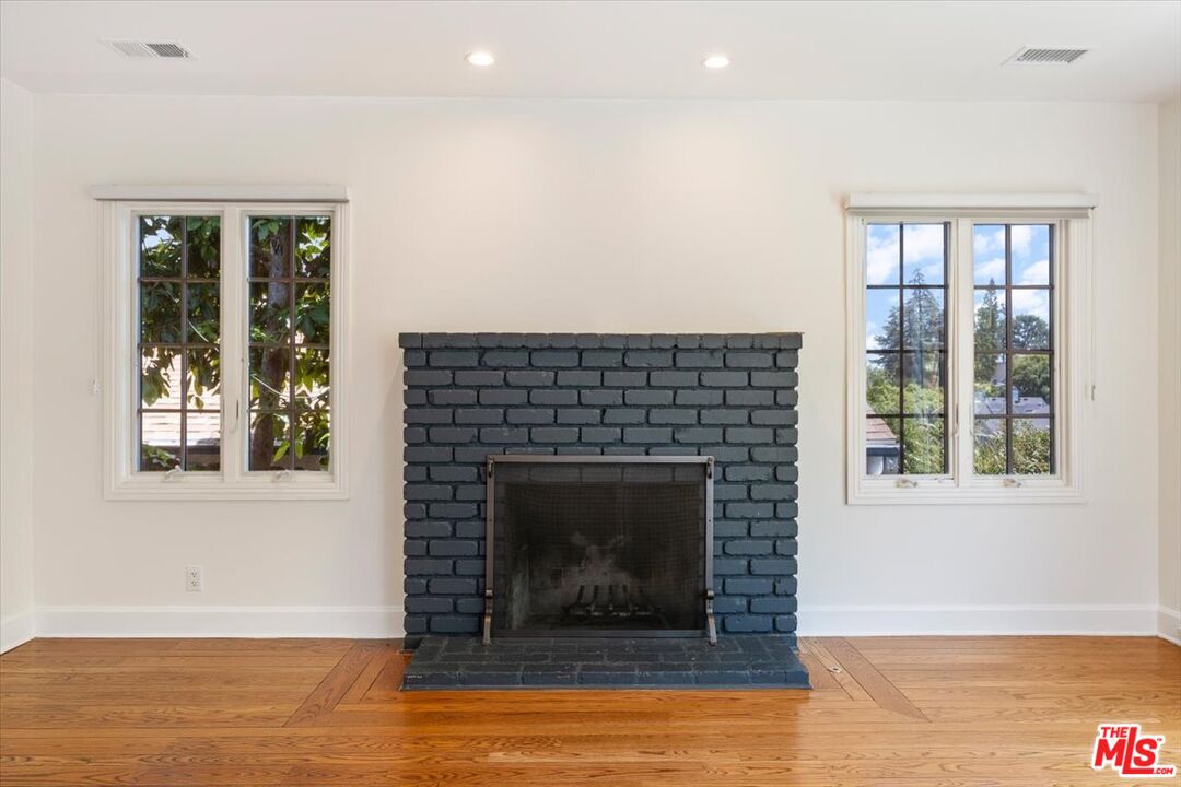 14041 Roblar Road Sherman Oaks, CA 91423 - Photo 6 of 47 a living room with a fireplace and a floor