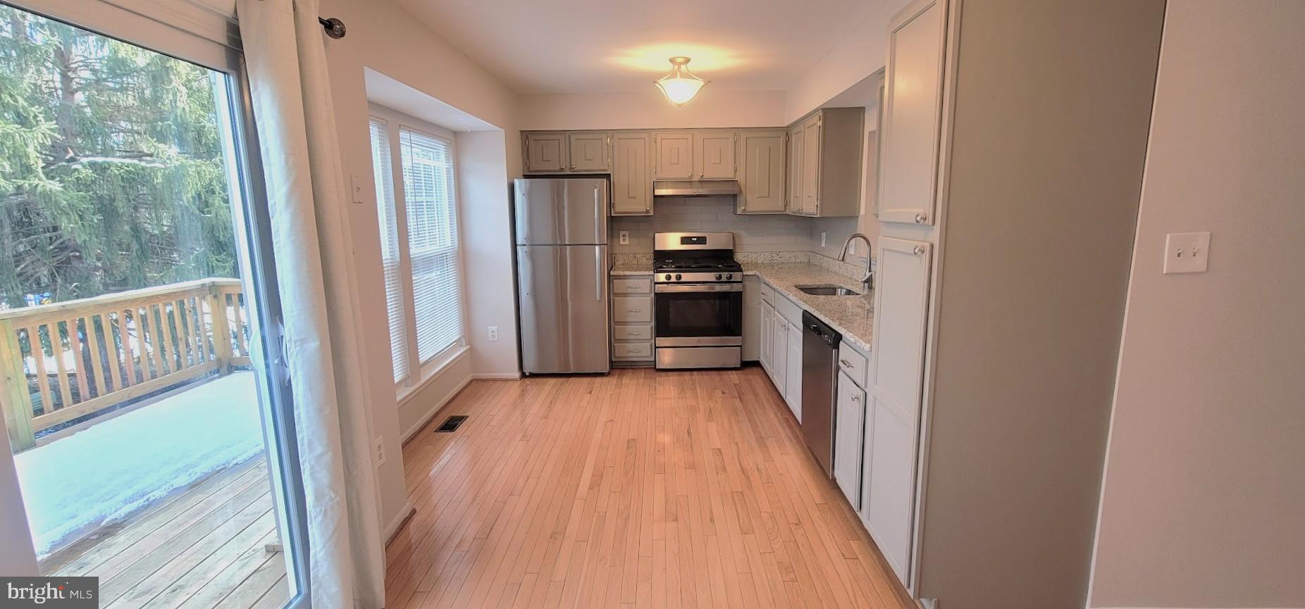 12 Sebastiani Boulevard Gaithersburg, MD 20878 - Photo 7 of 21 Modern kitchen with natural light and deck access.