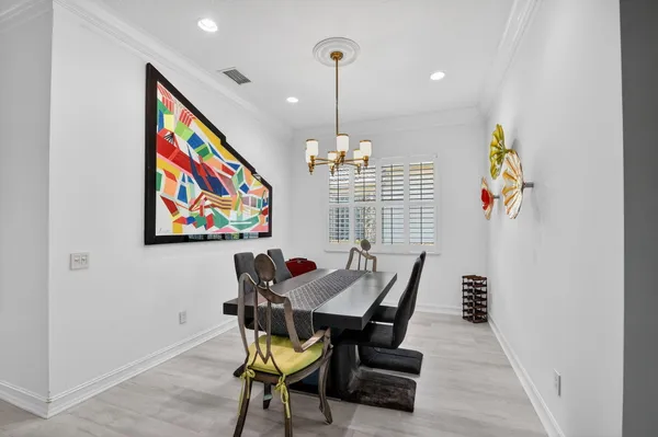 a living room with furniture and kitchen view with wooden floor