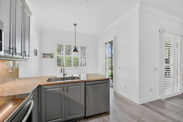 a bedroom with a bed and a flat tv screen on dresser