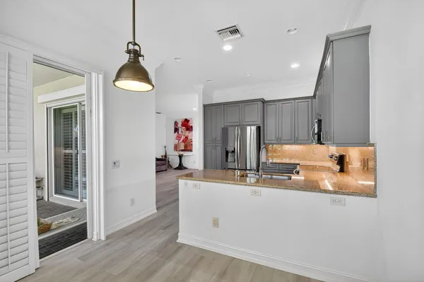 a bathroom with a sink a large mirror and a shower