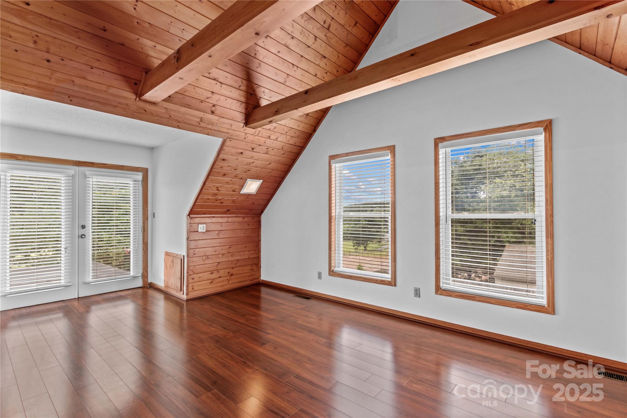 296 Hicks Creek Road Troutman, NC 28166 - Photo 16 of 48 a view of an empty room with a window and wooden floor