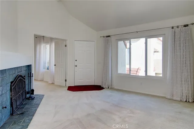 a view of empty room with window and closet