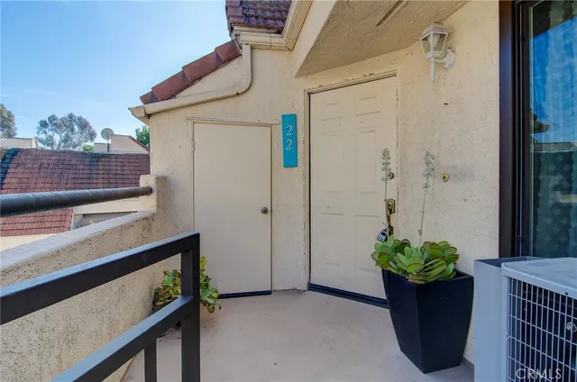 a view of a house with a wooden bench