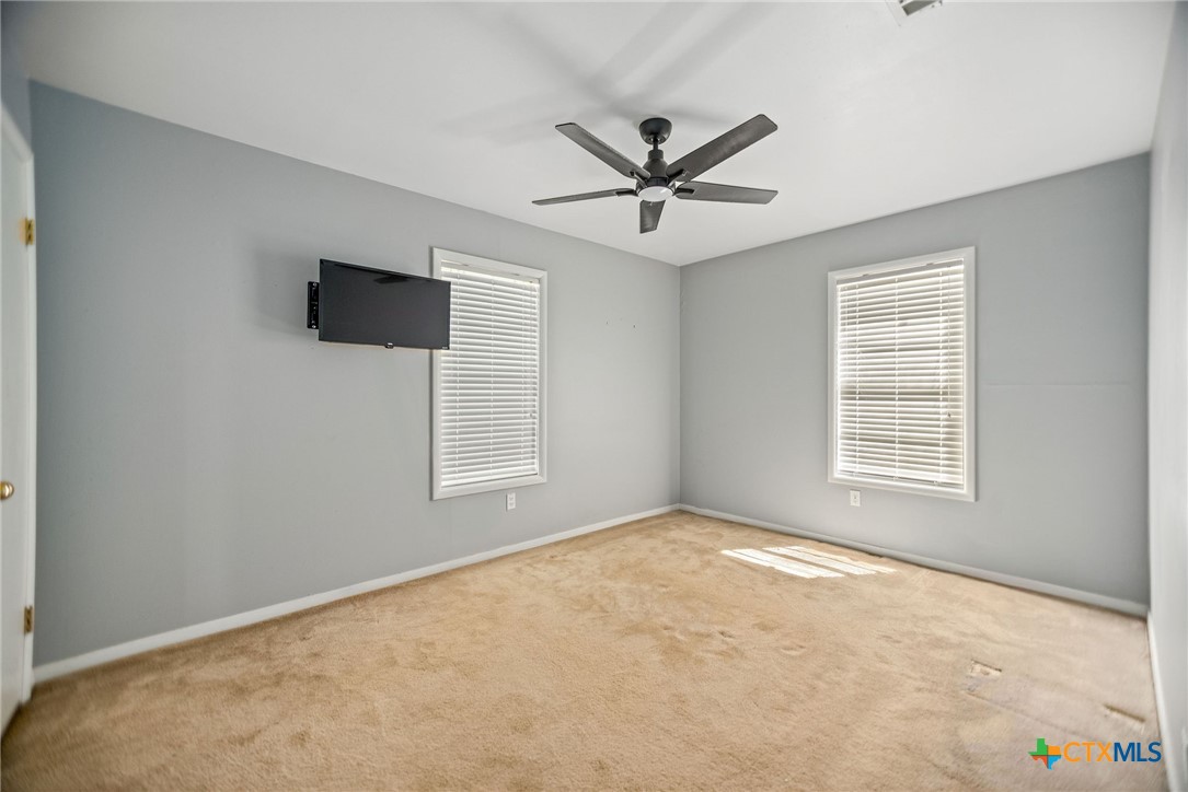 525 Travis Street Port Lavaca, TX 77979 - Photo 12 of 24 a view of a livingroom with a ceiling fan and window