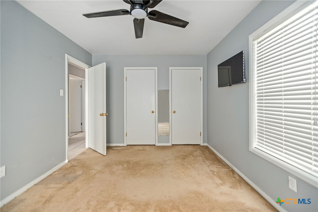 525 Travis Street Port Lavaca, TX 77979 - Photo 13 of 24 a view of a livingroom with a ceiling fan and window