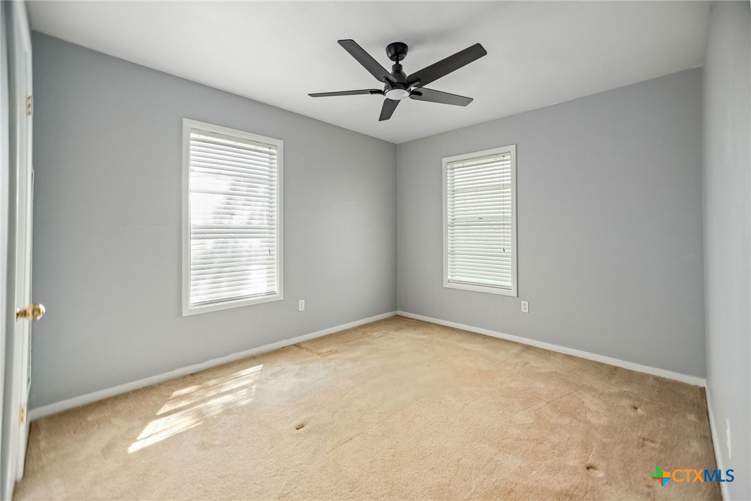 525 Travis Street Port Lavaca, TX 77979 - Photo 17 of 24 a view of a livingroom with a ceiling fan and window