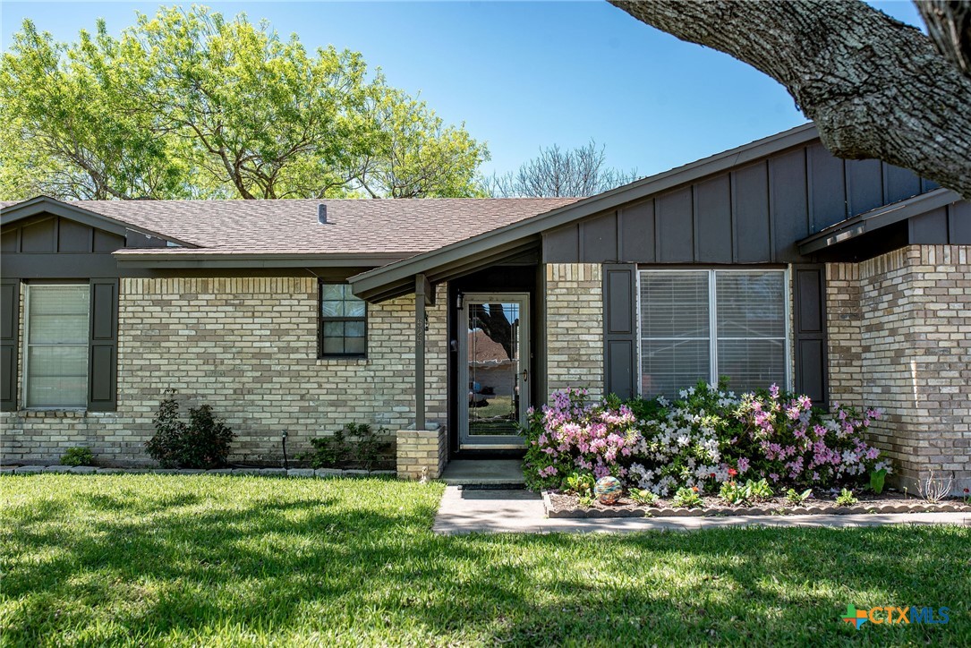 525 Travis Street Port Lavaca, TX 77979 - Photo 2 of 24 a front view of a house with a garden