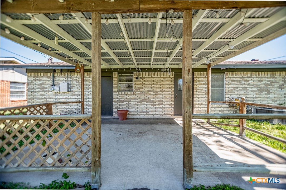 525 Travis Street Port Lavaca, TX 77979 - Photo 24 of 24 a view of a porch with a floor to ceiling window next to a yard