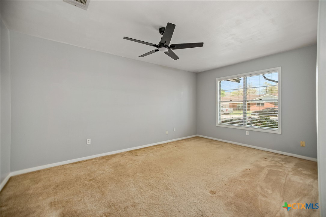525 Travis Street Port Lavaca, TX 77979 - Photo 4 of 24 an empty room with windows and fan view